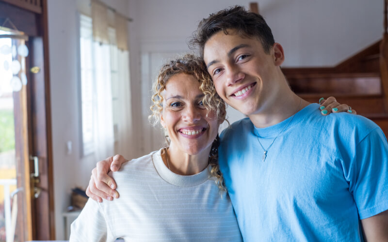 Mother with teenage son smiling