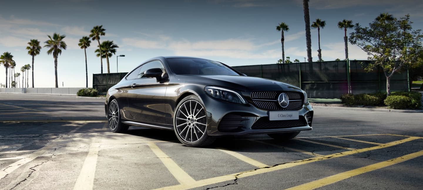 Angled front shot of dark grey Mercedes-Benz C-Class Coupe