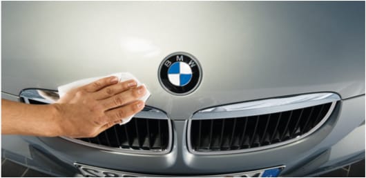 BMW technician polishing car bonnet