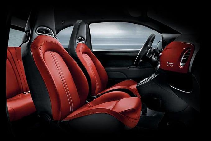 The interior of an Abarth 595 in black and red leather