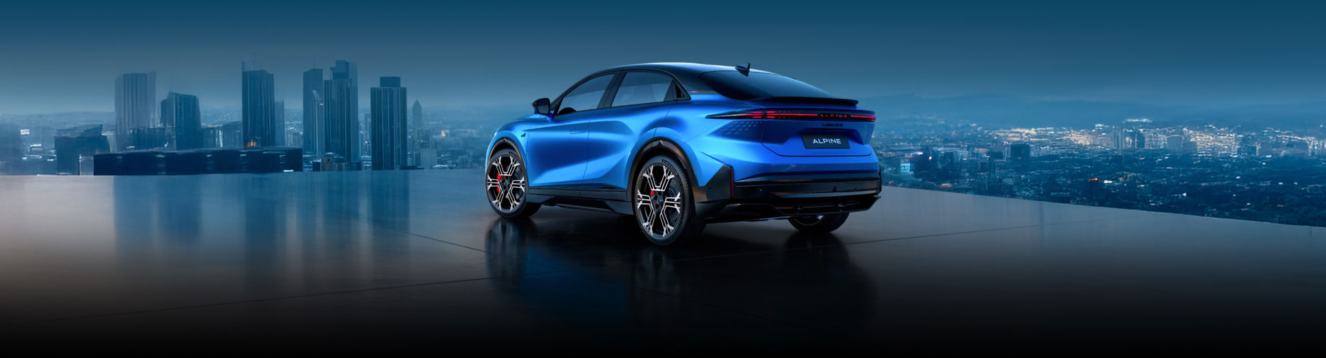 Rear side view of a blue Alpine A390 against a city backdrop