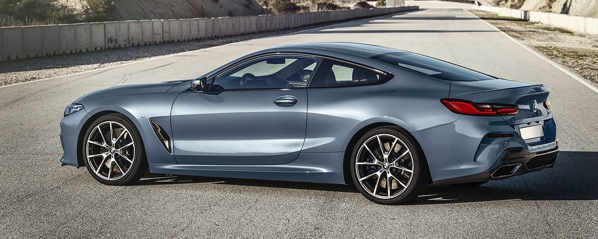 Silver BMW 8 Series parked on a motorway.