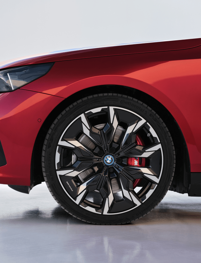 Side view of red BMW i5 M60 alloy whels