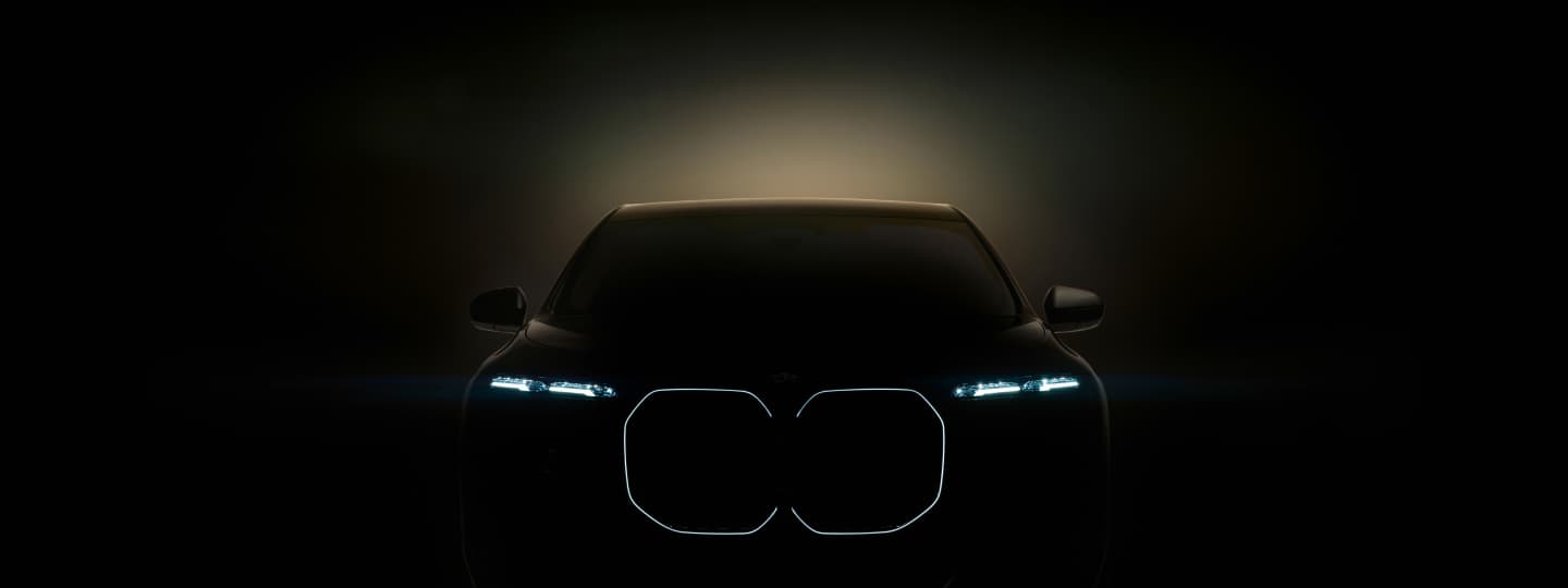 Front view of the BMW i7 with headlights on