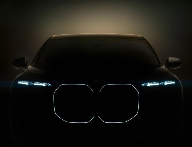 Front view of the BMW i7 with headlights on