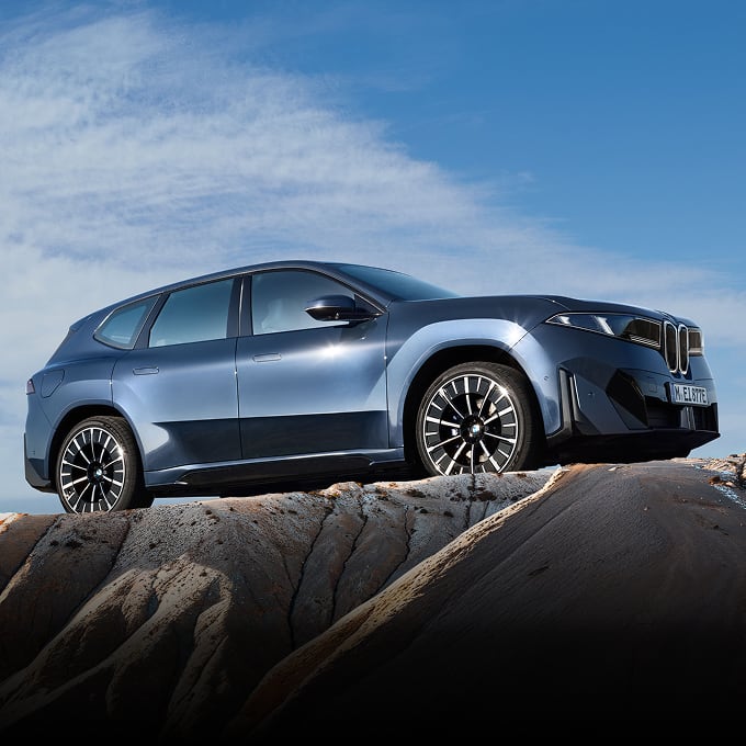 Side angled view of BMW iX3 on top of mountain