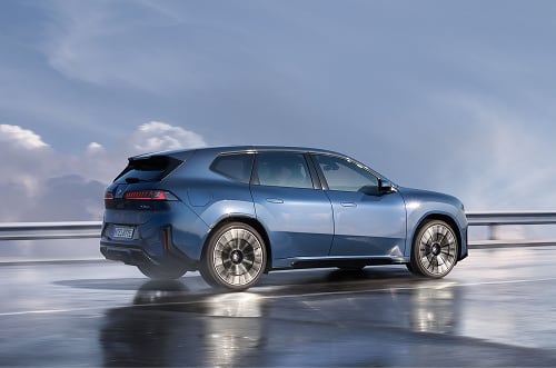 Rear angled view of BMW iX3 on the road