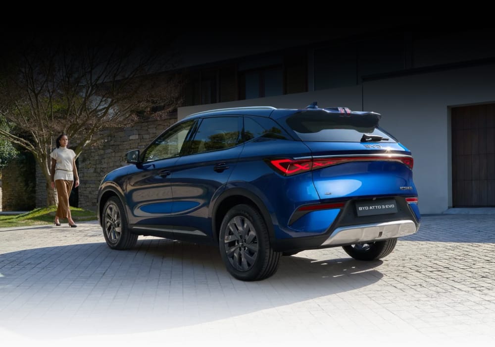 Rear quarter view of BYD ATTO 3 Evo on driveway