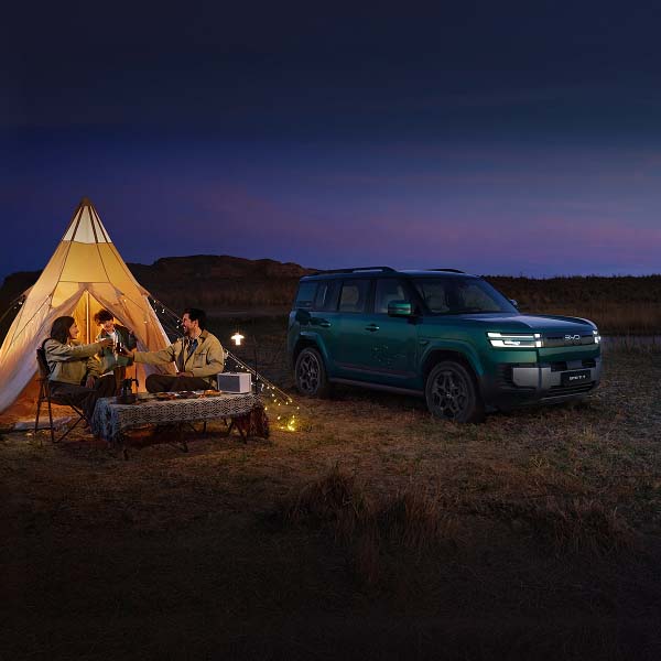 Family camping at night with Ti 7 in background