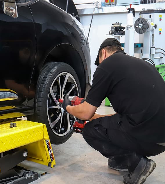 Staff member working on a cars alloy wheels