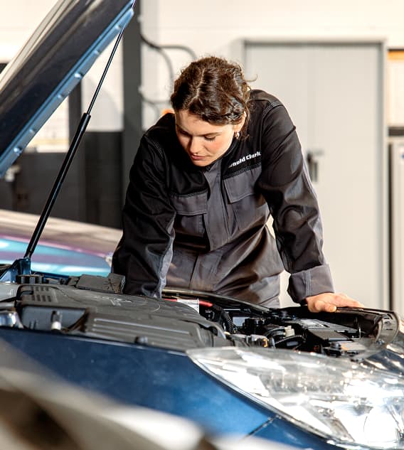 Staff member looking inside bonnet of car