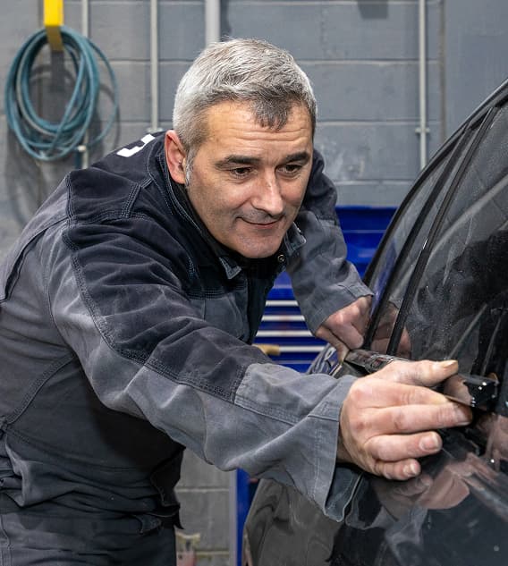 Staff member working on outside of a car