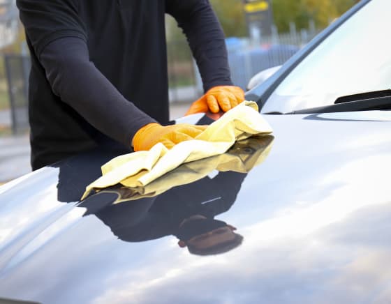 Man polishing car bonnet