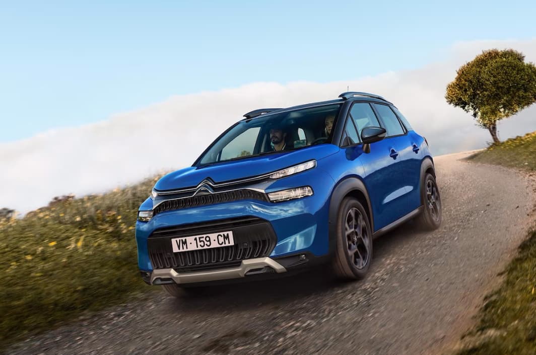 Blue Citroën C3 Aircross driving along a country road