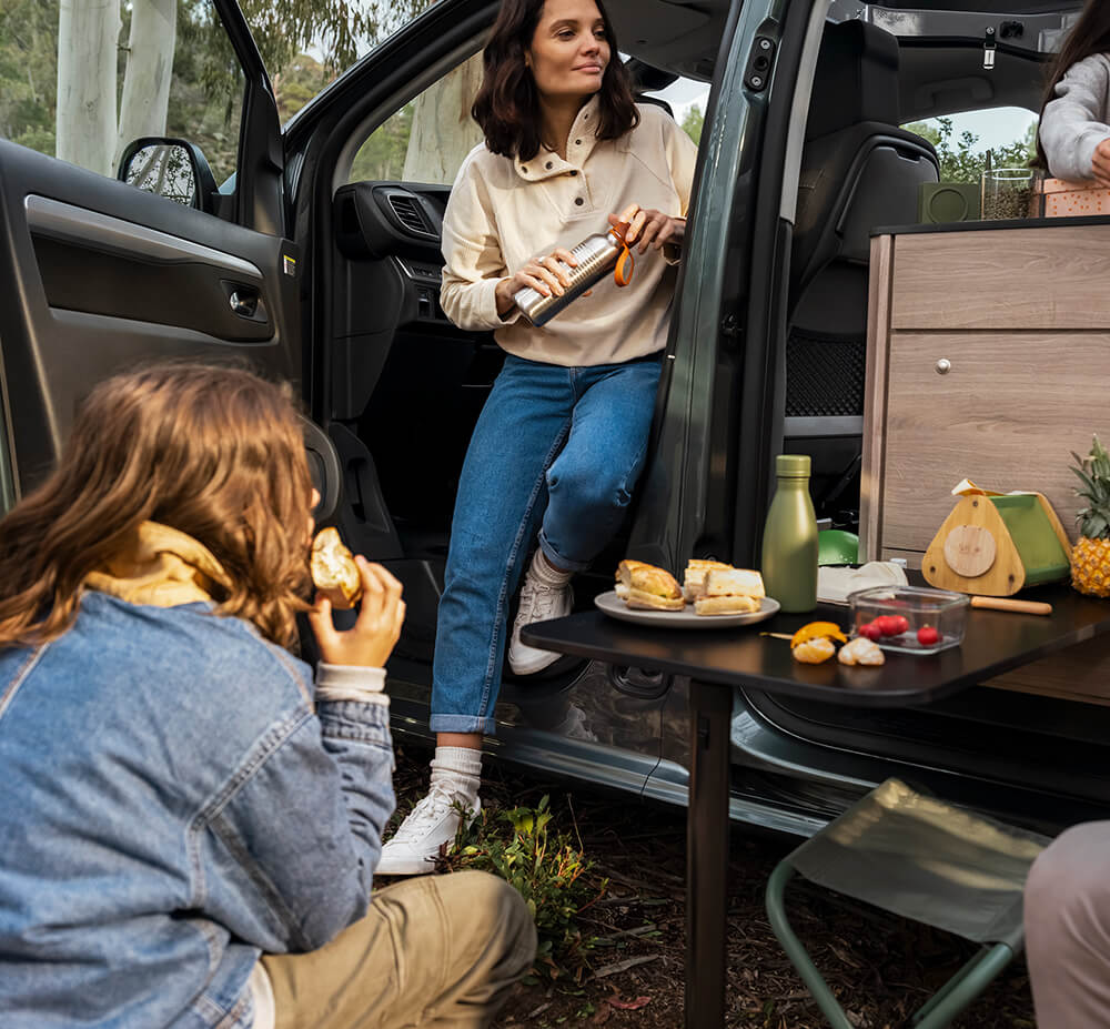 Family enjoying outdoor dining option with Citroën Holidays