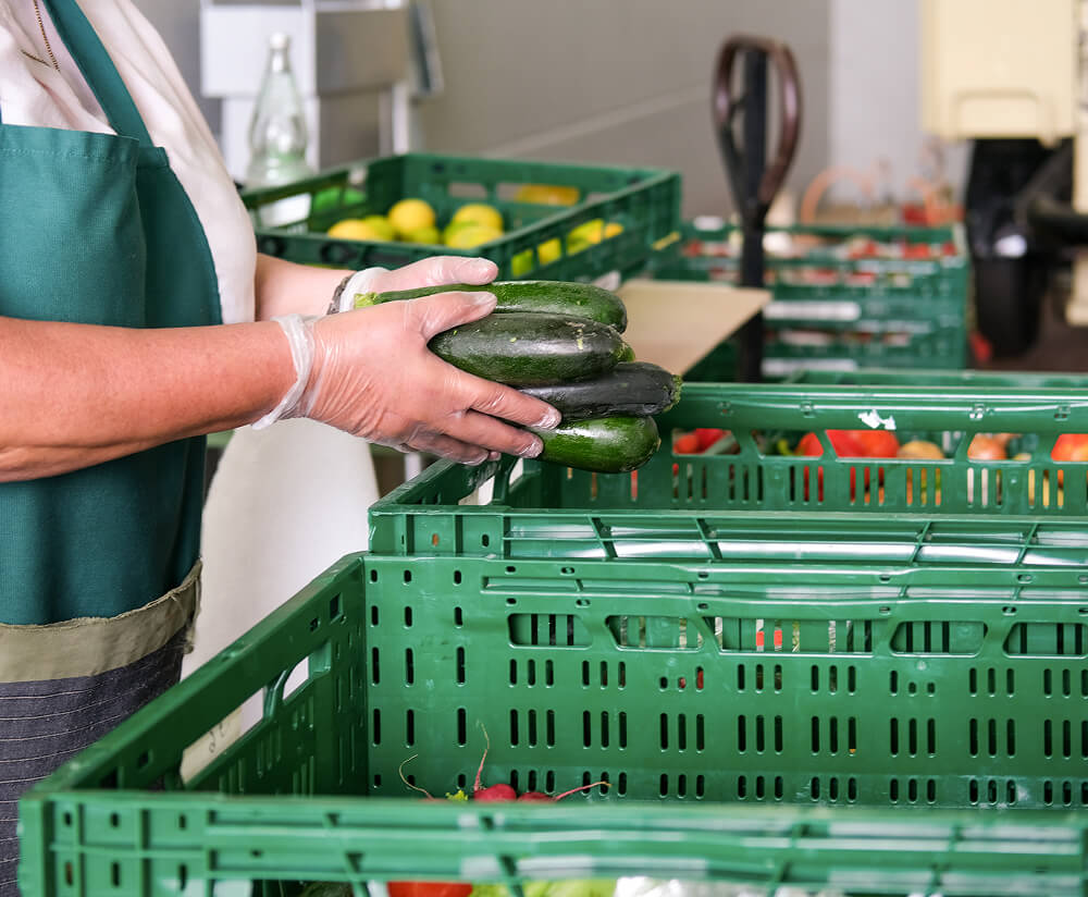 Person packing fruit and vegetables