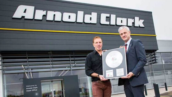 Cheque being handed over from Eddie Hawthorne to Geroge Bowie in aid of Cash for Kids