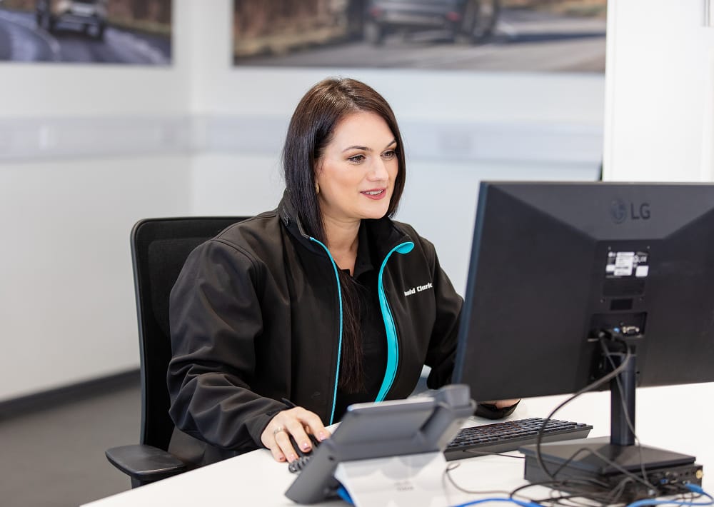 Arnold Clark Product Consultant at desk with computer