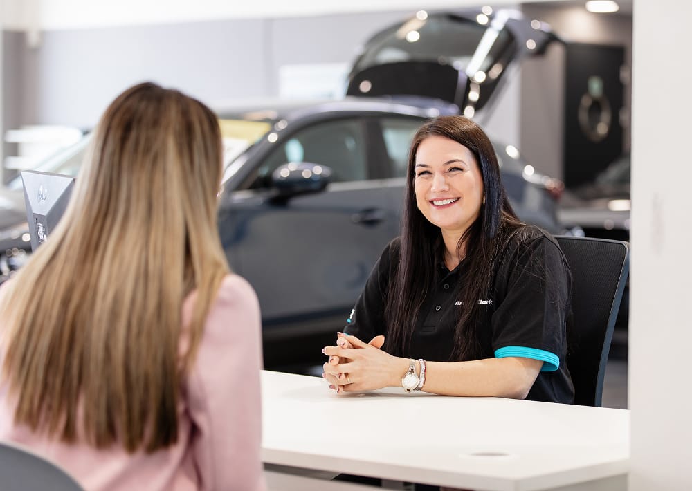 Arnold Clark Product Consultant sitting with customer at desk