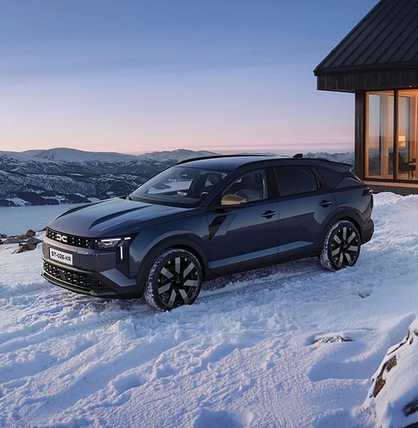 Dacia Striker parked outside a mountain chalet in the snow