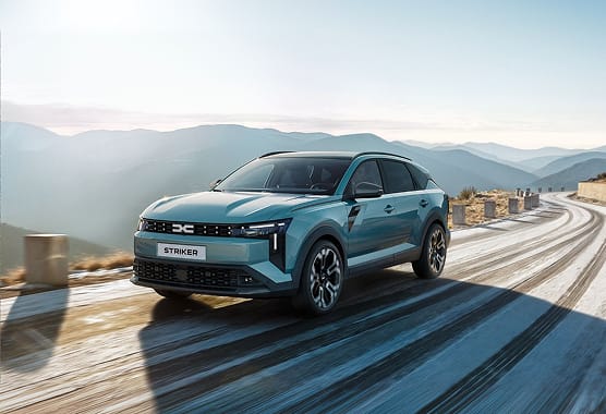 Dacia Striker Hybrid 150 traveling up snowy mountain pass