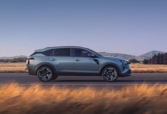 Side view of Dacia Striker Hybrid 155 on country road