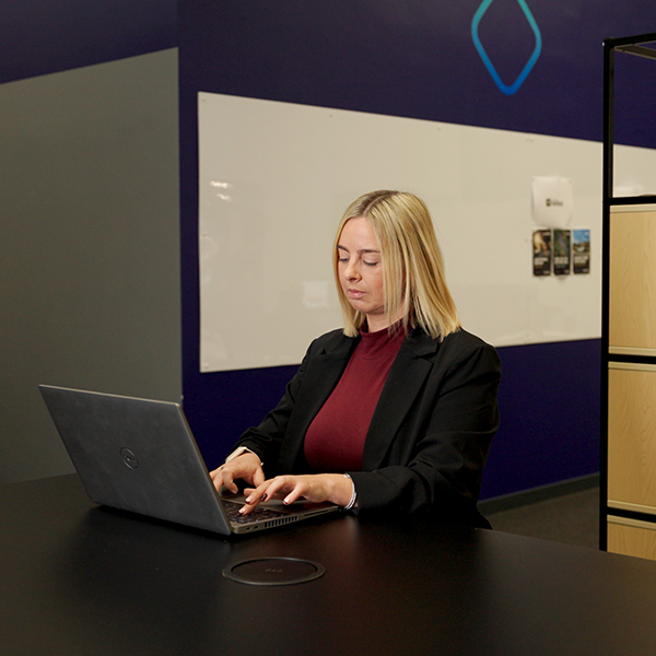 Graduate accountant at desk on laptop