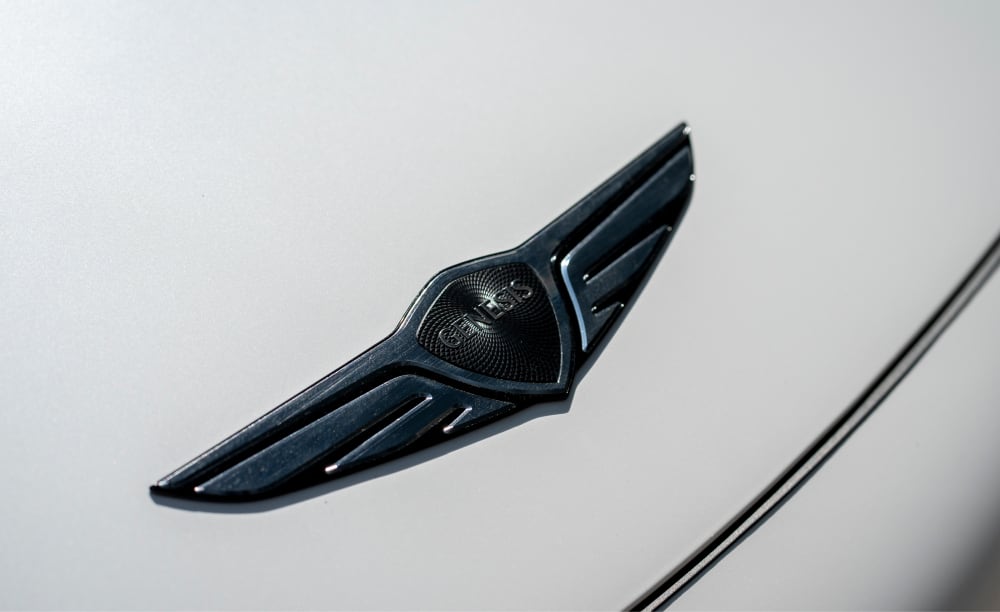 Close up of Genesis logo on car