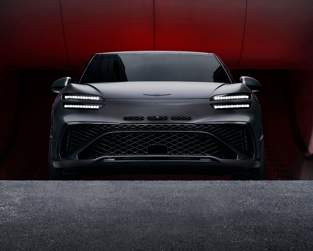 Genesis GV60 from the front driving out a tunnel