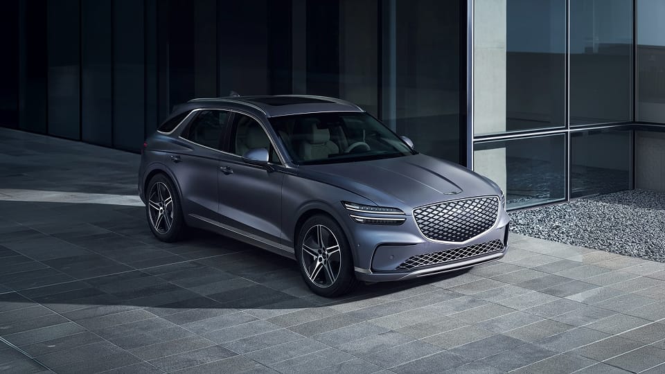 Genesis GV70 parked outside modern office building