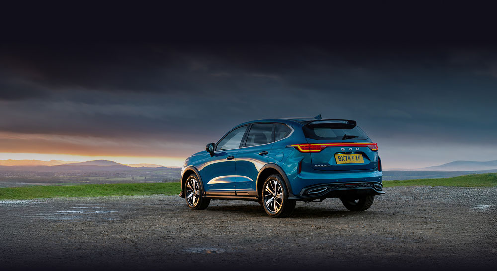 Rear side view of Haval Jolion at the side of a country road