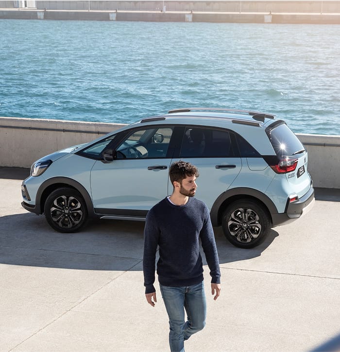 Side on view Premium Sunlight White Pearl Honda Jazz at waterfront