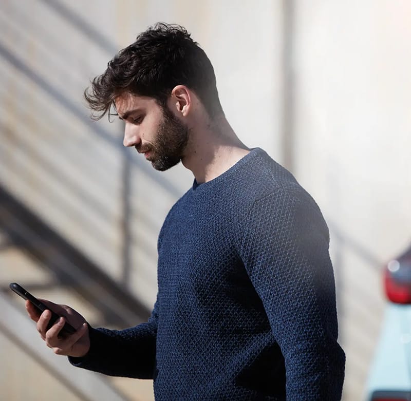 Man using My Honda+ app on their phone