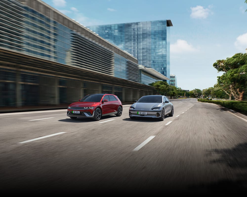 Hyundai Ioniq 5 and Ioniq 6 driving on city street.