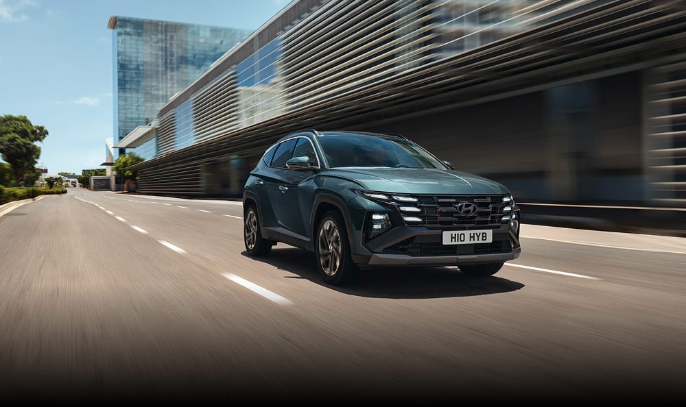 Hyundai TUCSON driving on city street.