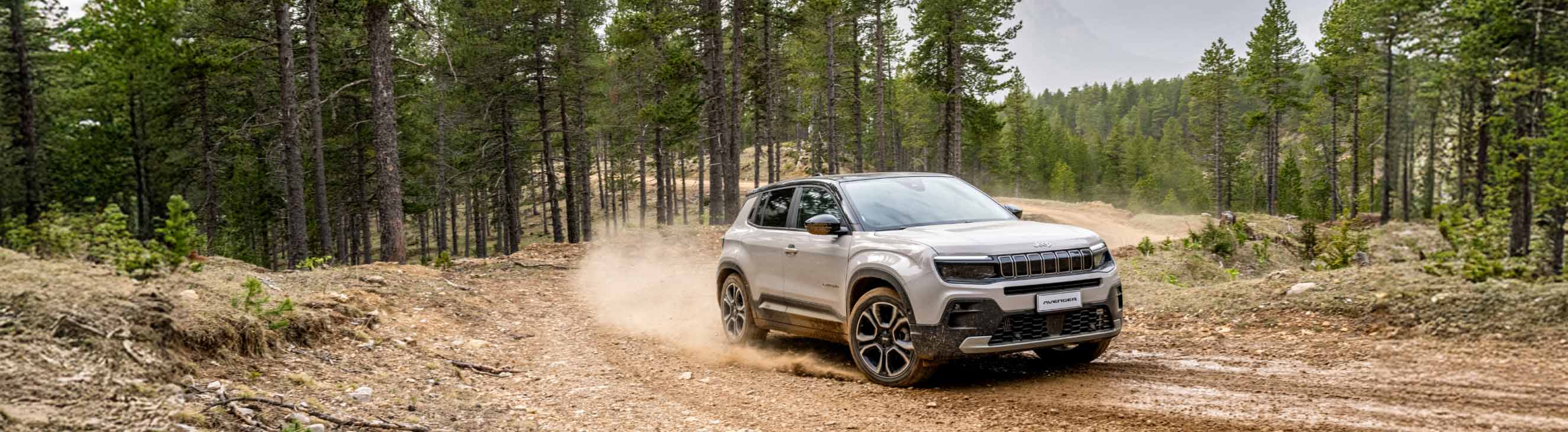 Jeep Avenger driving on gravel forest road