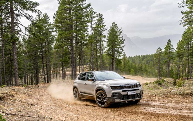 Jeep Avenger driving on gravel forest road