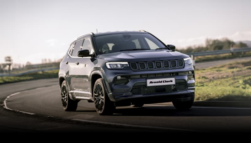 Grey Jeep Compass on road.