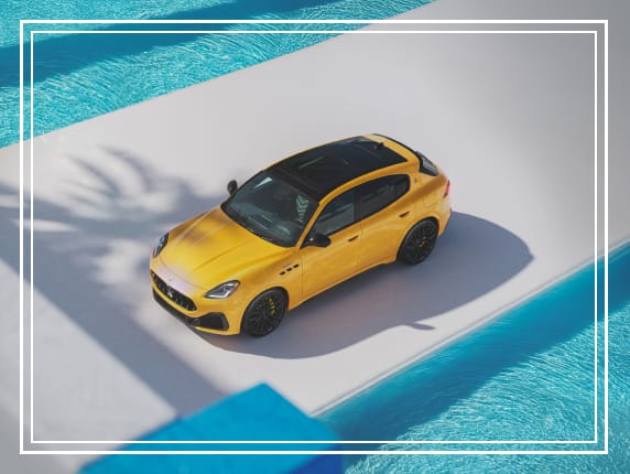 Yellow Maserati Grecale Trofeo beside a pool.