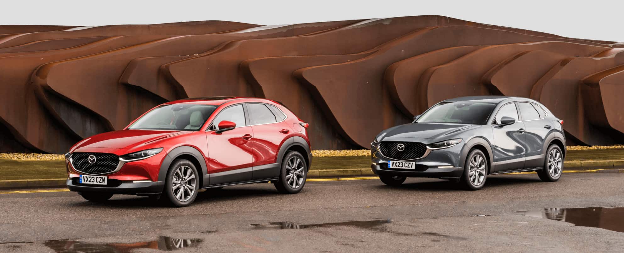 Angled front / side view of Mazda CX-30 skyactiv-G and Mazda CX-30 skyactiv-X parked side by side.