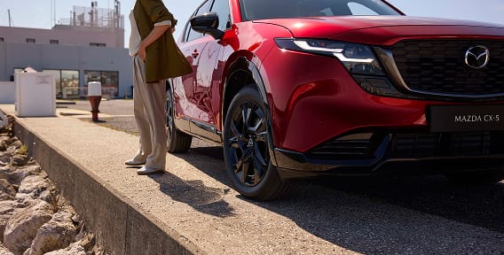 Lifestyle image of woman standing outside Mazda CX-5