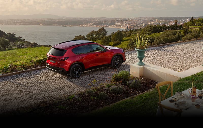 Rear view of Mazda CX-5 parked infront of a seaside landscape