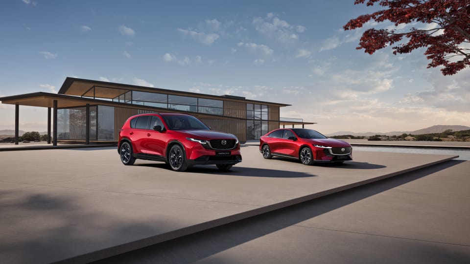 Mazda CX-5 and Mazda 6e parked outside minimalist modern building