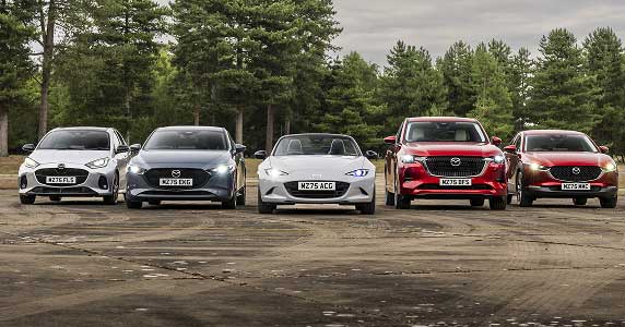 Mazda range of cars in a car park