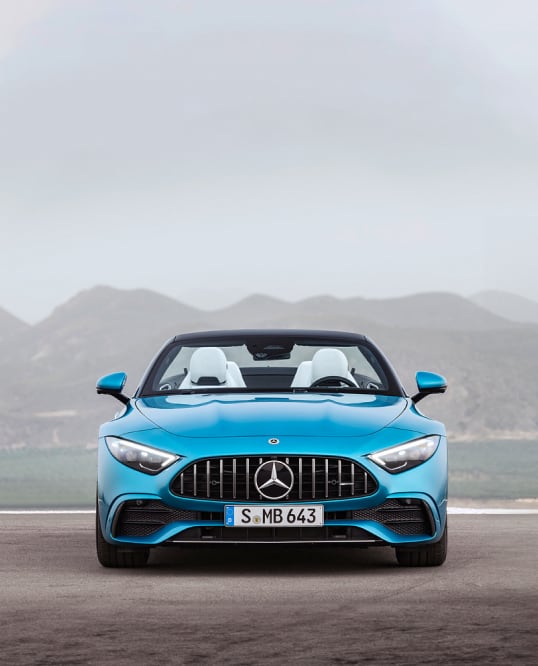 Front view of Mercedes AMG-SL car parked outside mountainous background