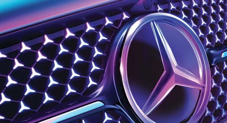 Close up image of Mercedes-Benz logo and grille