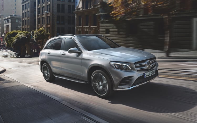 Mercedes-Benz GLC model driving through a city center