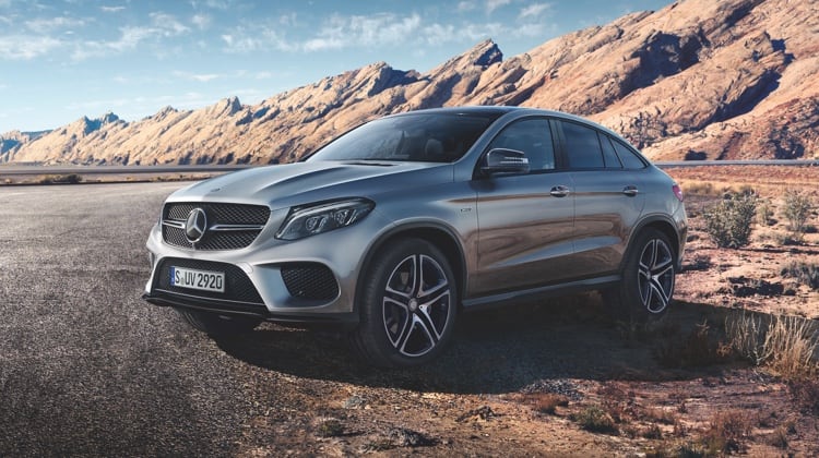 Mercedes-Benz GLE Coupe model parked next to a hilly terrain