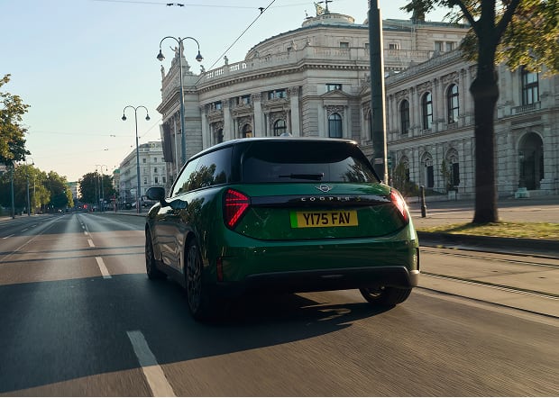 Rear angled view of green MINI Cooper on city street