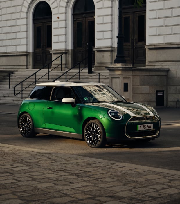 Front angled view of green MINI Cooper on city street
